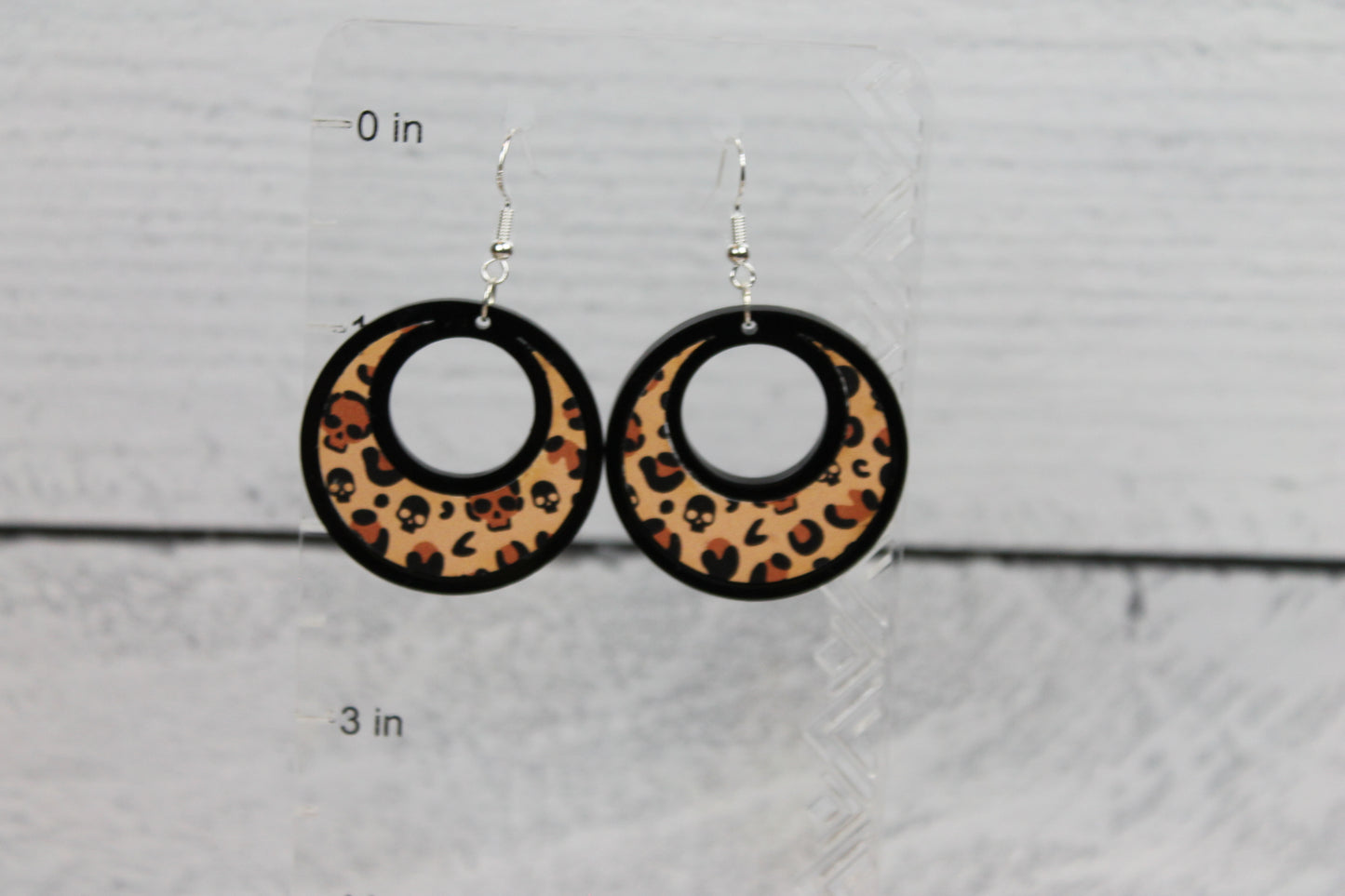 Leopard pattern dropped hoop earrings, fashion statement styled jewelry layered wood and acrylic plastic. pattern has skull detail within